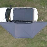 Freestanding 180-degree awning with two support poles and integrated color-changing dimmable LED lights, shown outdoors on a patio.